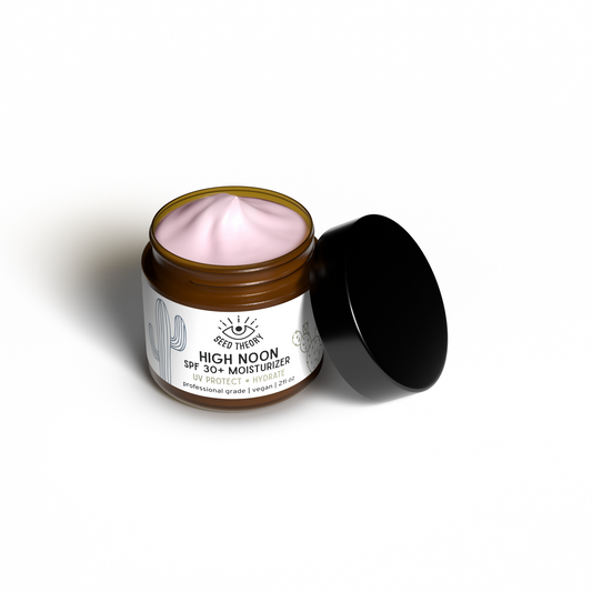 Jar of 'High Noon' moisturizer with pink cream on a white background