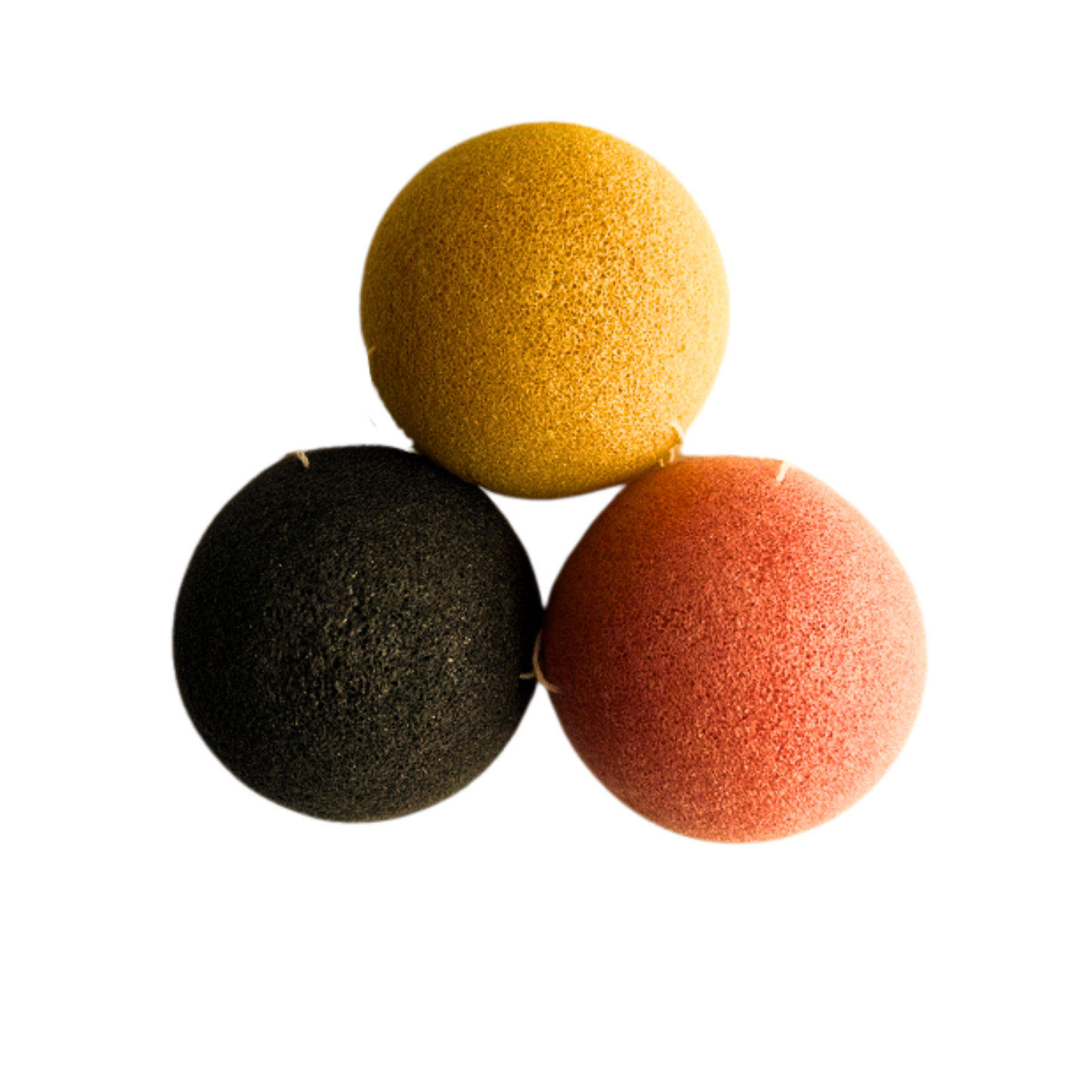 Three colorful Konjac Sponge balls in yellow, black, and pink on a white background