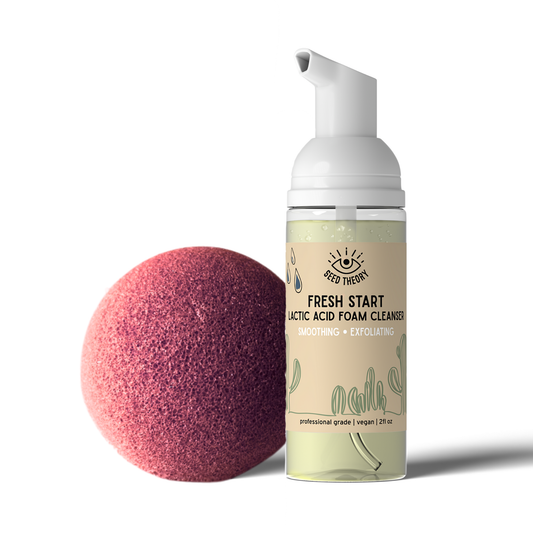 Foam cleanser bottle and pink exfoliating konjac sponge on a white background
