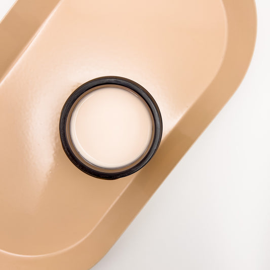 Top of jar filled with moisturizer on a orange plate